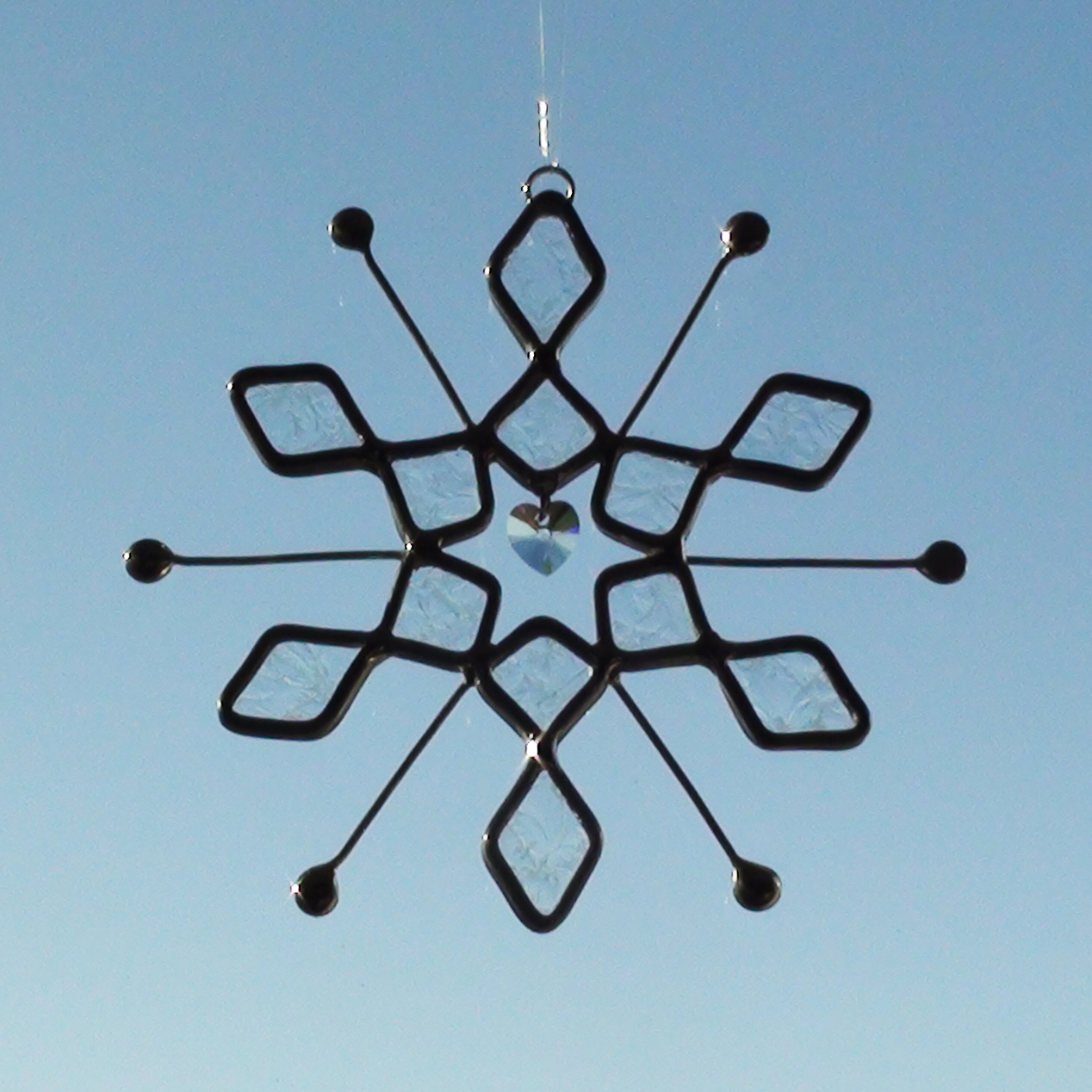Sun Catcher made with a Stained Glass Glue Chip Snowflake Design with a Crystal Heart in the Middle