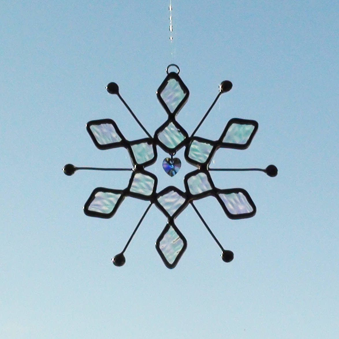 Suncatcher made of Iridescent Stained Glass Snowflake Design with Crystal Heart in Middle